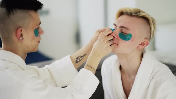 Gay Couple Having Fun Using Eyes Patches in Bathrobe