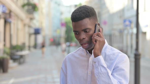 African Man Getting Angry on Call in Street