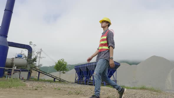 Engineer Walking On Industrial Factory Site alt