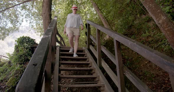 beautiful woman walking in forest exploring lush garden 