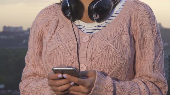 A Modern Girl Types Something on Her Smartphone