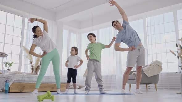 Sport Family Doing Warmup Before Yoga Training