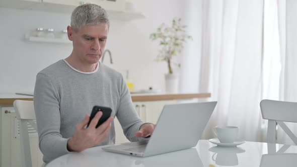 Senior Old Man Using Smartphone at Home