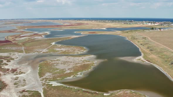 Beautiful flight in summer over salt lakes. Dry lakes. Green grass.