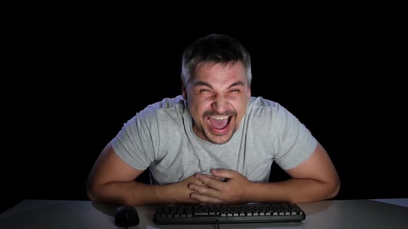 Man Laughs From Watching Online Videos on the Internet