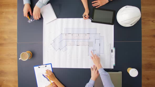 Business Team with Blueprint Working at Office