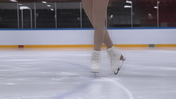 Girl Standing In Ice Skates In Ice Rink