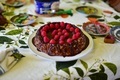 decadent photo of a freshly baked chocolate raspberry cake adorned with fresh red raspberries - PhotoDune Item for Sale