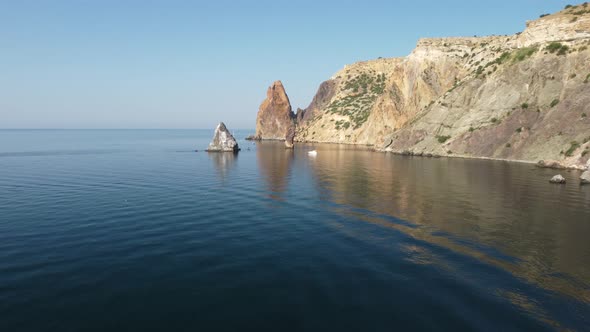 Aerial View From Above on Calm Azure Sea and Volcanic Rocky Shores