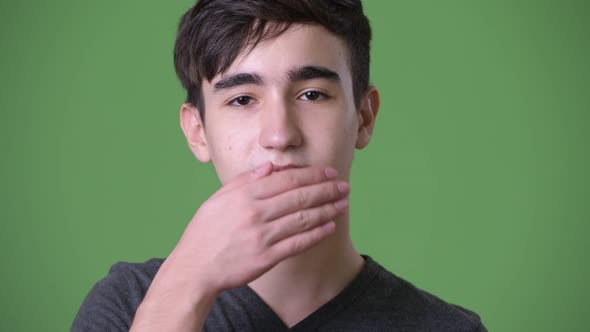 Young Handsome Iranian Teenage Boy Against Green Background