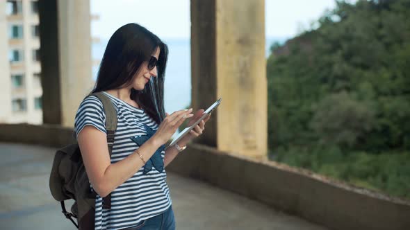 Female Traveler is Looking on Digital Tablet