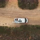 Two men lays on top of van drone shot zooming out - VideoHive Item for Sale