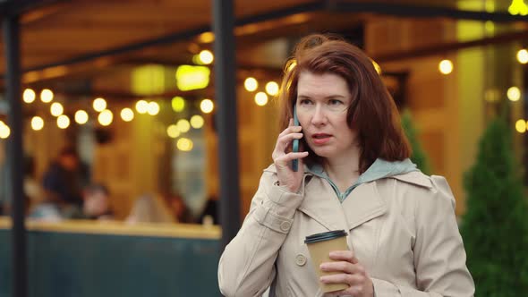 Business Woman Talking on Phone During Coffee Break