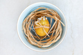 Yellow colored Easter egg with spring flowers in a bowl, top view - PhotoDune Item for Sale