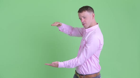 Portrait of Happy Businessman Snapping Fingers and Showing Something