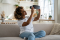 Excited African American woman looking at her first VR headset and feeling excited to get immersed - PhotoDune Item for Sale