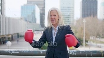 esswoman screaming clashing boxing gloves outdoors