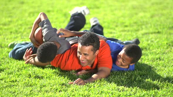 Group portrait of a father and his sons with a football