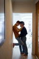 Tender scene of a gay couple standing at home - PhotoDune Item for Sale