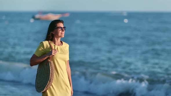 Woman Walking on Sea Shore at Sunset Admiring Natural Seascape