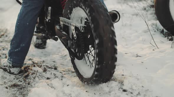 Man Biker Doing Tire Burnout in the Snow Field Slow Motion
