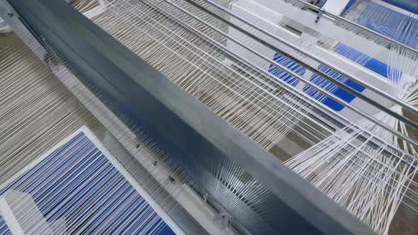 Fabric Woven on a Modern Machine at a Textile Factory. Textile Industry Concept.