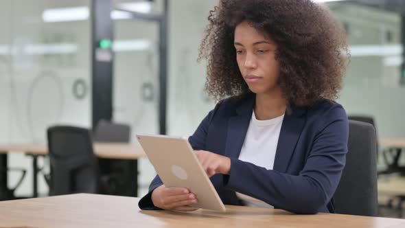 Young African Businesswoman Using Tablet for Work