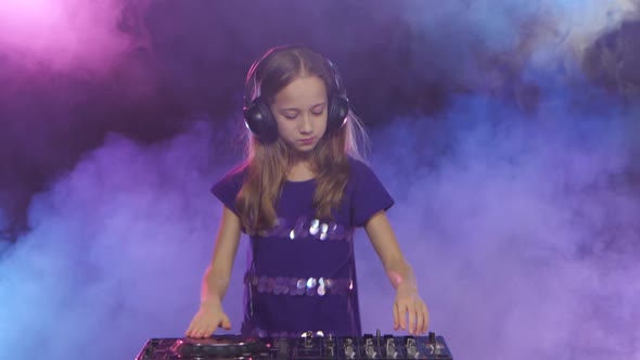 Teenager Girl in Smoky Studio Background Plays for Dj Console