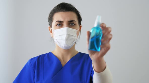 Female Doctor or Nurse Showing Hand Sanitizer