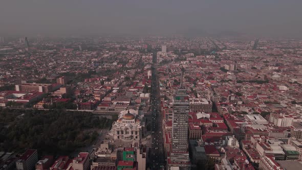 Flight over Palacio de Bellas Artes in mexico city downtown in a very polluted day