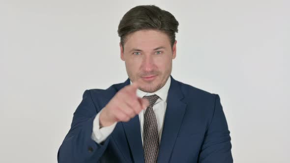 Middle Aged Businessman Pointing at the Camera, White Background