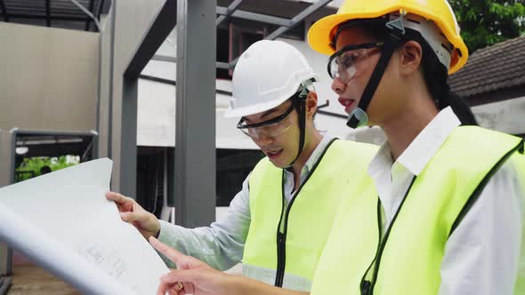 Asian colleague construction workers people wearing protective safety helmet and glasses on site.