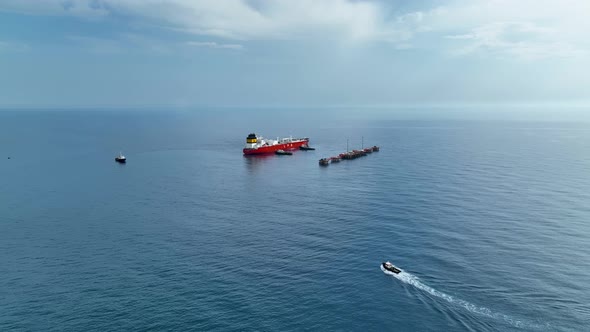 Tugs help the gas tanker to go to sea aerial view 4 K Turkey Alanya