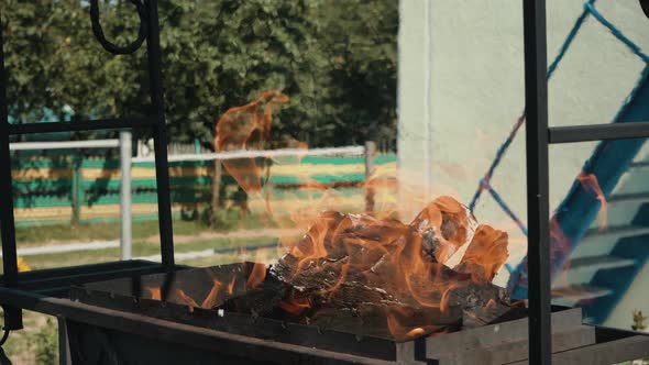 Firewood is Burning in the Grill Preparing Coals for Frying Meat Open Fire