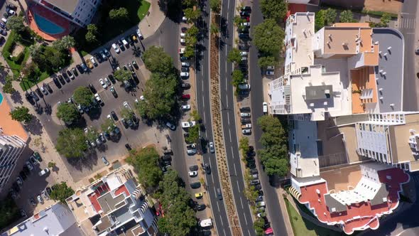 Topdown Aerial View of the Roofs of the Road and Streets Between Small Colorful Houses in the Center