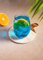 Blue curacao cold cocktail with orange slice and ice. Summer party or bar menu concept. - PhotoDune Item for Sale