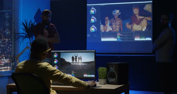 Young Man Editing Video Inside a Room