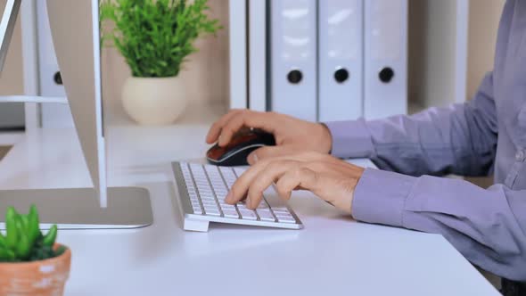 Close Up Male Typing on White Keyboard