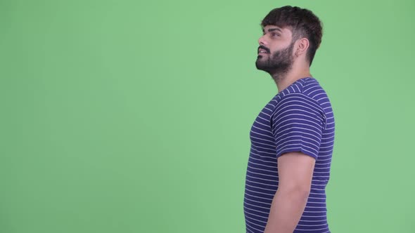 Profile View of Happy Young Overweight Bearded Indian Man Smiling