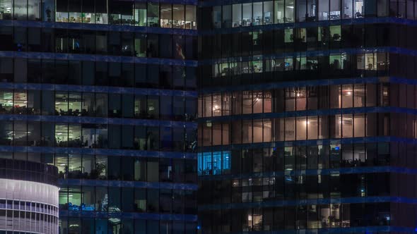Close Up View to Office Windows in Skyscrapers of City at Night Timelapse From Top