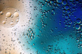 Colorful background with drops of water and oil and a brown and blue background. - PhotoDune Item for Sale