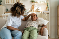 Caring African American mother touching forehead of sick little boy son - PhotoDune Item for Sale