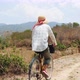Young Woman Farmer In A Straw Hat Rides A Bicycle On the Countryside Road.  Footage.  - VideoHive Item for Sale