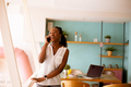 Young black woman using mobile phone in the cafe - PhotoDune Item for Sale