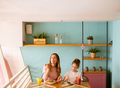 Mother and daughter having a breakfast with fresh squeezed juices in the cafe - PhotoDune Item for Sale