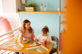 Mother and daughter having a breakfast with fresh squeezed juices in the cafe - PhotoDune Item for Sale