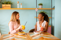 Young black and caucasian woman having good time, drinking fresh juices and having healthy breakfast - PhotoDune Item for Sale