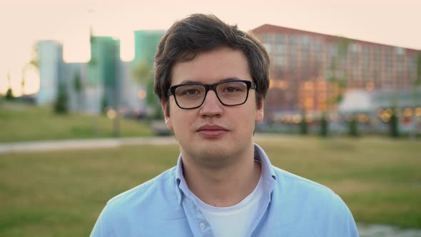 Portrait Shot of Man Looking Straight at the Camera on Background of Park