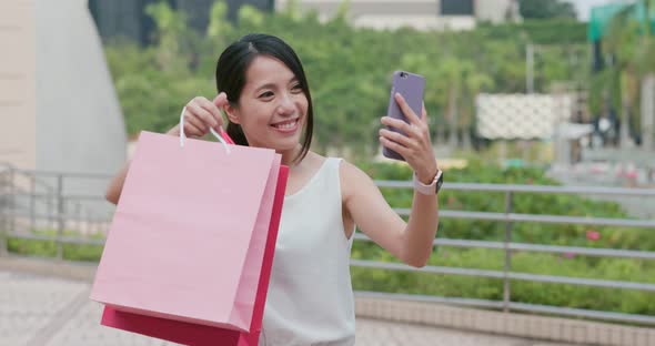 Woman Make Video Call on Cellphone with Holding Lots of Shopping Bag