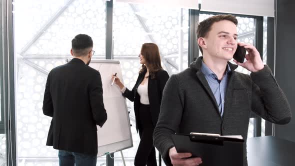 Three Coworkers Working on a Project at Office